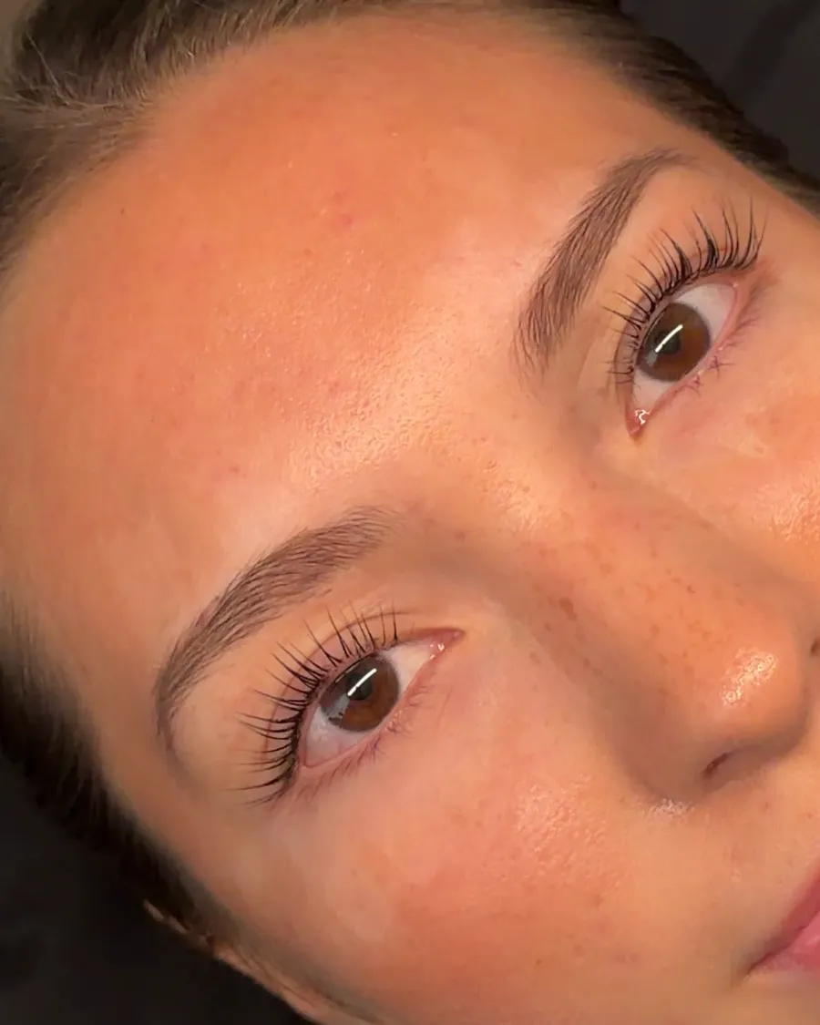 A client's lifted, tinted natural lashes after a Korean Lash Lift + Tint